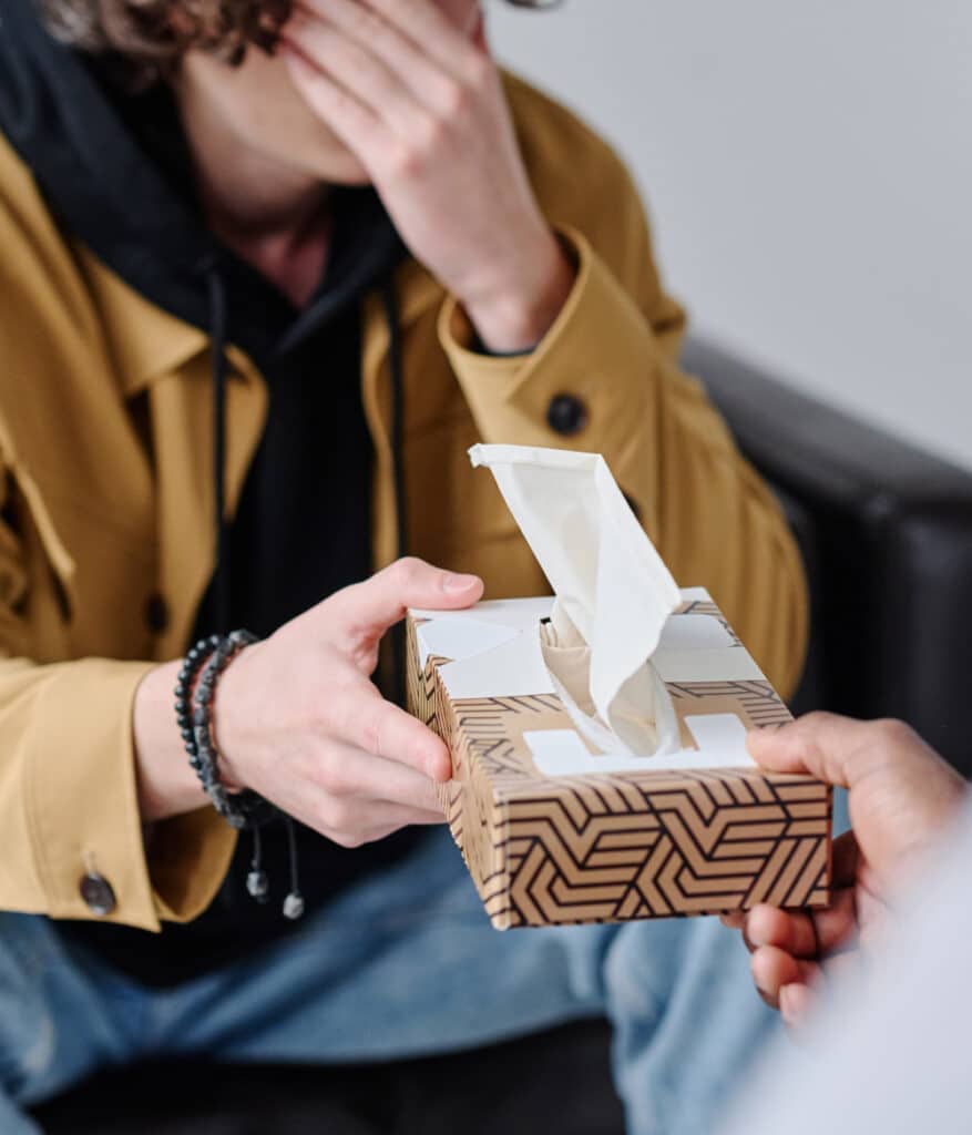 man holding box of tissues at emdr therapy appointment in rverside